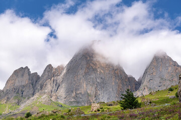 Clouds cover the peaks of the mountains. View of the Caucasus Mountains in Ingushetia, Russia