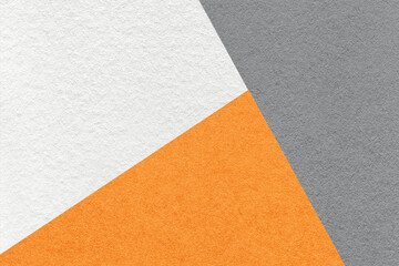 Texture of craft gray, white and orange shade color paper background, macro. Vintage abstract cardboard