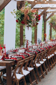 wedding holiday banquet in the open air. covered, served tables in the yard, garden in nature. wooden tent covered with fabric, wedding banquet