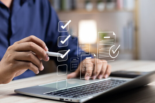 Business performance monitoring and evaluation concept, Take an assessment, Business man using laptop and tablet online checklist survey, Filling out digital checklist, Questionnaire with checkboxes.