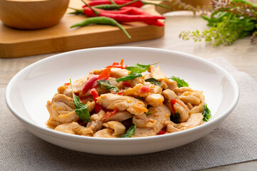 Close up Stir-Fried sliced chicken breast with Basil on white plate