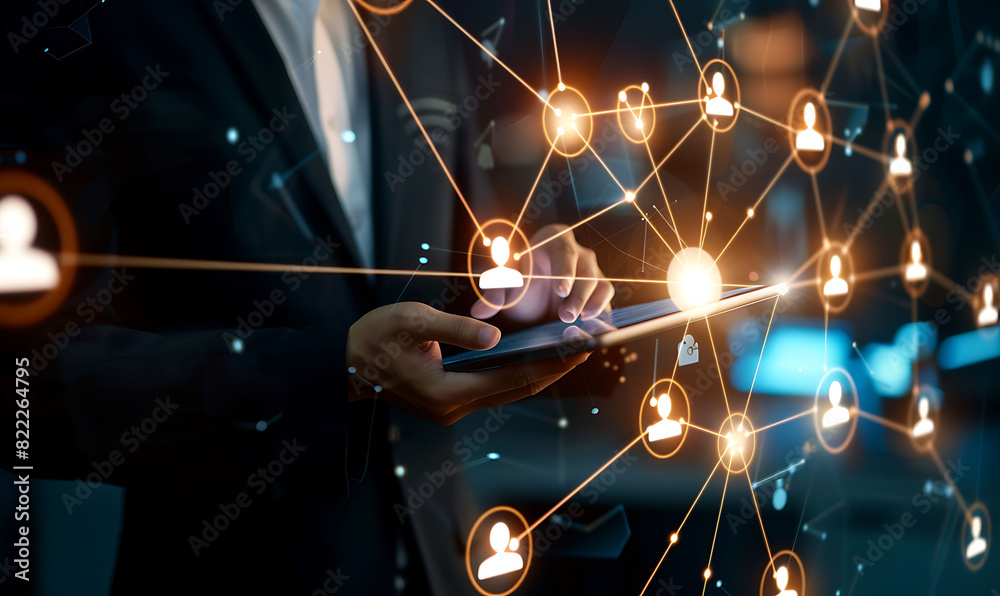 Leinwandbilder A businessman using a digital tablet to manage customer relationships, featuring a virtual network overlay of interconnected icons, representing CRM and global communication