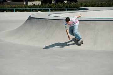 A young skater boy confidently rides his skateboard up a steep ramp in a sunny outdoor skate park.