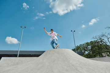 A young skater boy is fearlessly riding his skateboard up the side of a vert ramp at a skate park...