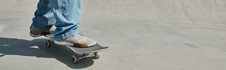 A young skater boy showcases his skills as he rides a skateboard on a cement surface in a vibrant...