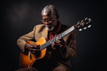 Obraz premium Portrait of a content afro-american man in his 80s playing the guitar isolated on blank studio backdrop