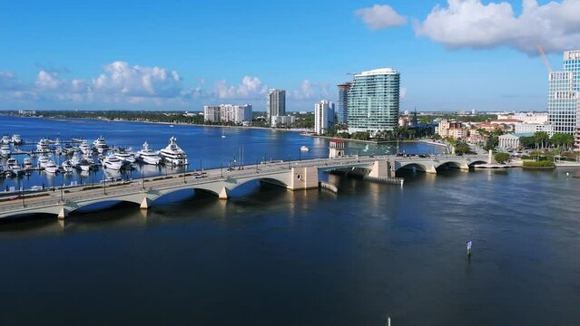 Panoramic view of Royal Park Bridge in West Palm Beach, Florida. Metal construction spanning over body of water with boats docked on left side