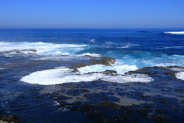 Stormy waves breaking on the stony beach in Fuerteventura in Jandia Natural Park