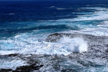 Stormy waves breaking on the stony beach in Fuerteventura in Jandia Natural Park