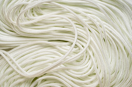 coils of white thin paracord background