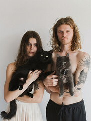 Embracing Feline Elegance: A Couple's Portrait with Beloved Cats