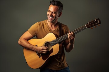 Portrait of a grinning man in his 40s playing the guitar isolated in light wood minimalistic setup