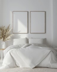 Two empty mockup paintings hang in the bedroom, against the background of a bed with white linens. Minimal interior.