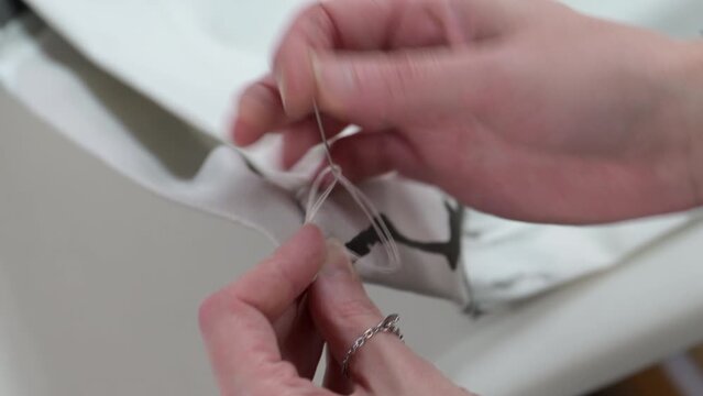 Skilled seamstress sewing fabric detailed closeup, luxury hand made designer product
