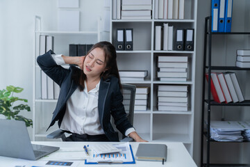 Stress at work, sitting with a stressed face, standing and stretching the body of an office woman.