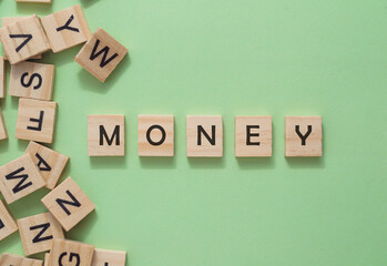 A jumble of wooden letters spell out the word money