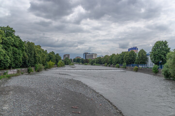 The overflowing mountain river flowing through the city during the rainy season. The Terek River in...