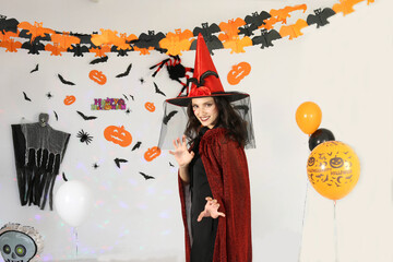 Portrait of cute woman wearing dressed carnival halloween costumes makeup posing with bats and...