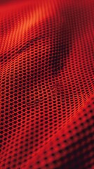 Naklejka premium Vibrant red mesh fabric with intricate texture