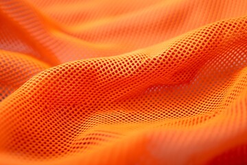 Orange mesh fabric with intricate texture and wave pattern
