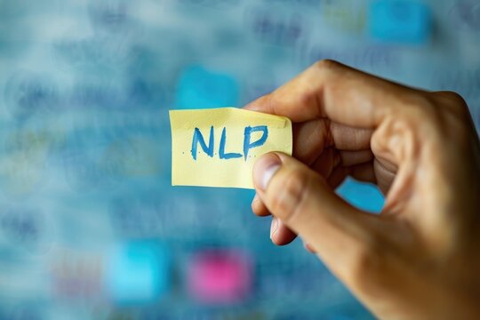 Person holding a note with the text NLP for natural language processing