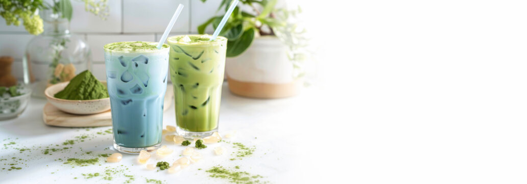 Trendy green and blue matcha drink banner. Colorful Japanese tea latte green and blue moon milk in glass with ice and straw. Tea made from dried butterfly pea flowers and tea tree leaves. Copy space