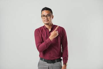 A handsome young Asian man in a suit wearing glasses and making various facial expressions isolated on a white background