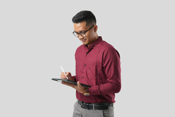 A handsome young Asian man in a suit wears glasses and makes various facial expressions while using...