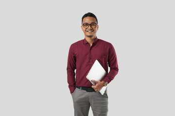 A young handsome Asian man in a suit wearing glasses and making various facial expressions and holding a laptop.
