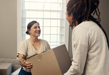 Box, real estate and interracial couple in living room for mortgage, residence or moving. Partners,...