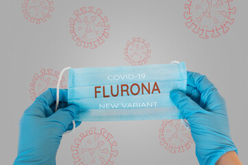 A person is holding a blue face mask with the word Fluorna written on it