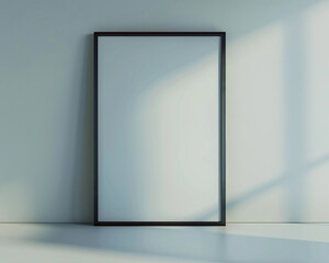 An upscale architectural studio with one empty white frame with dark borders, spotlighted and positioned at a slight upward angle against a light gray wall. 
