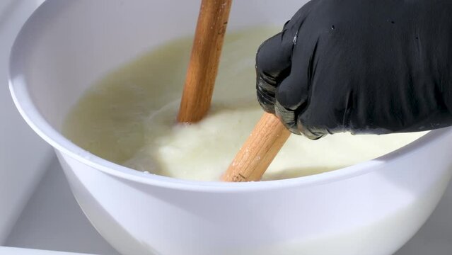 Caciocavallo how to prepare kachakovala cheese step by step in a home craft cheese factory, female hands in black latex gloves prepare a delicious product Italy Switzerland