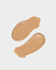 Makeup foundation, beige concealer swatch smudge smear on white background. BB CC cream texture