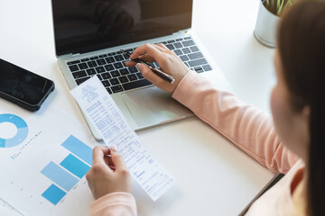 Deduction planning, debt asian young woman  hand using calculator to calculating money balance from...