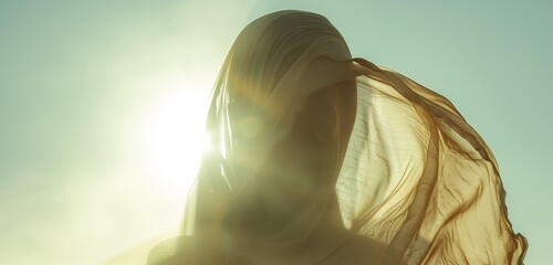 Desert scene with a woman’s face covered by airy fabric, sunlight creating dramatic shadows.  - Powered by Adobe