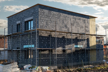 modern thermal insulation materials. building New House in process insulation of the wall of the...