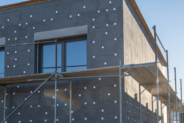 modern thermal insulation materials. building New House in process insulation of the wall of the...
