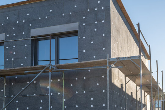 modern thermal insulation materials. building New House in process insulation of the wall of the house with layers Exterior covering in construction site.