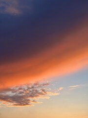 Cloud of gradient color from orange to dark blue during sunset