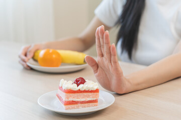 Diet asian young woman, girl hand push out, refuse eat piece strawberry cake, sweet or dessert...