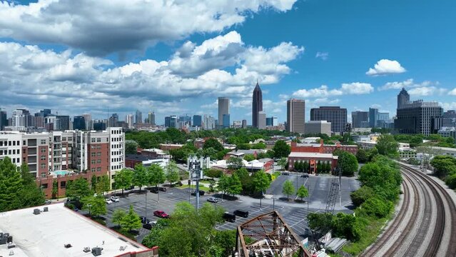 4K drone footage flying towards to the skyline of Atlanta Georgia.  Flow white clouds in a perfect blue sky and scenic urban landscape.  View from 400 feet above Atlanta on a clear day.