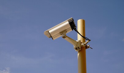 security camera in a post against the sky