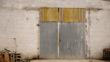 rustic industrial door in weathered facade as background