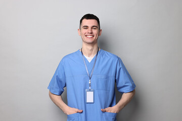 Portrait of smiling medical assistant on grey background