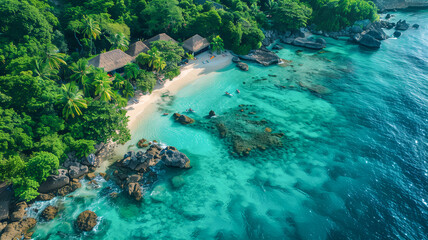 Aerial view of tranquil tropical beach with turquoise water, lush greenery, and beachfront cottages, ideal for serene getaway