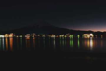 A distant view on Mt Fuji in Japan on a clear,The top parts of the volcano are covered with a layer of snow.