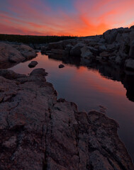 Colourful Sunset Reflected in Tidal Pool Along Shoreline