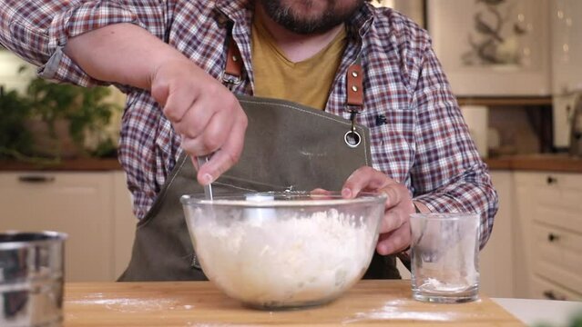 a male chef prepares the dough for making kutab
