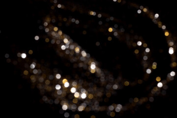 Golden and silver blurred bokeh lights on black background. Glitter sparkle stars for celebrate. Overlay for your design